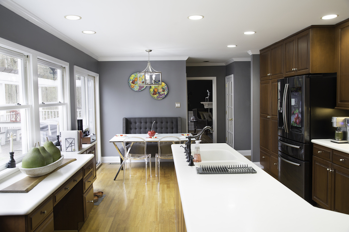 Interior of a grey kitchen with dark wood accents