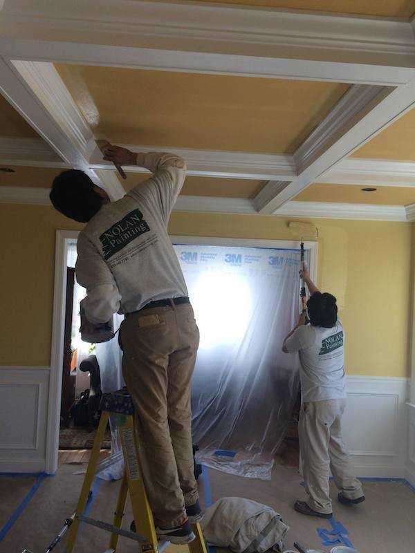 employees painting walls and ceiling