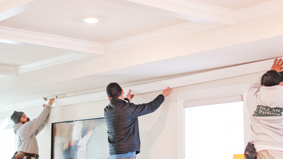 Nolan Painting carpentry team members Installing Crown Molding