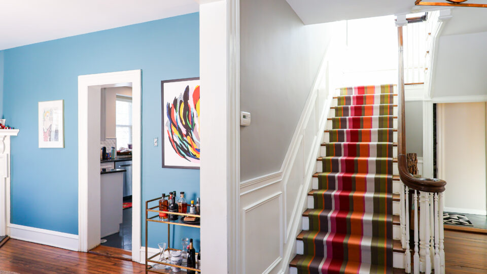 Bright Blue Dining room with a neutral entryway