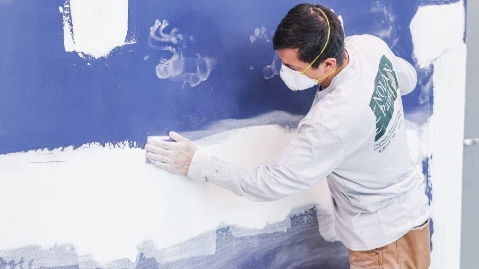 Sanding spackle on a commercial project