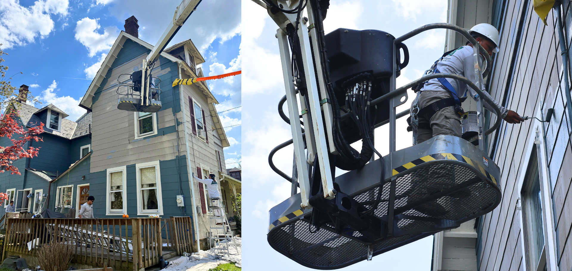 Workers on a boom lift painting an exterior of a blue house with scaffolding and safety gear visible in a sunny residential street.