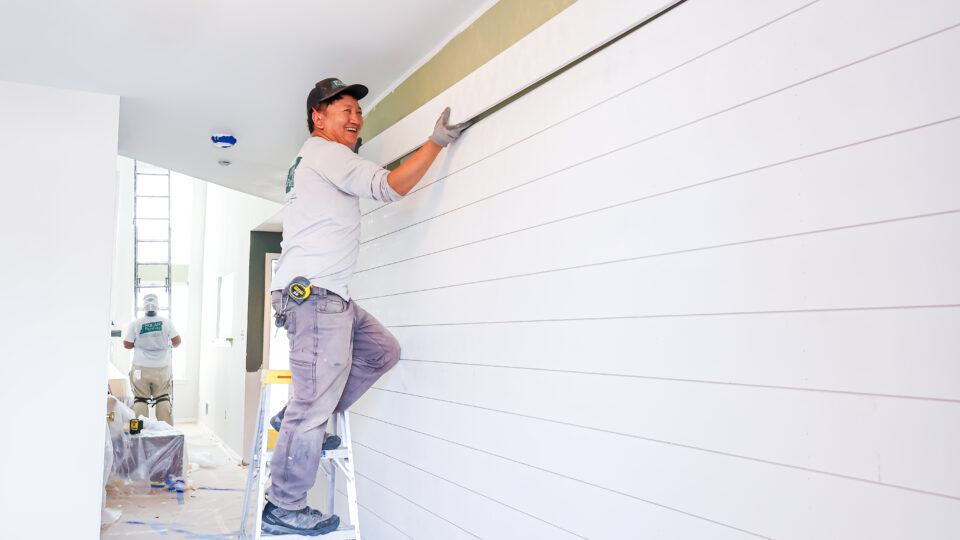 Nolan Painting Carpentry Team installs horizontal wall panels to add character to home's entryway.