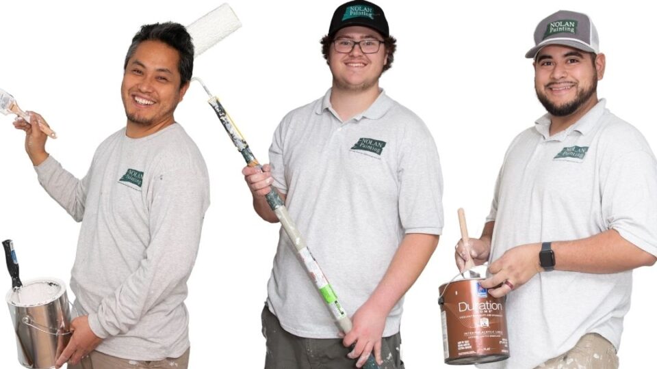 Three smiling painters pose with tools under the 'Join Our Friendly Team' headline, advertising job openings.